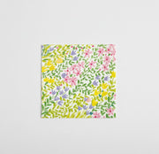 Floral patterned napkin with colorful flowers; beverage size