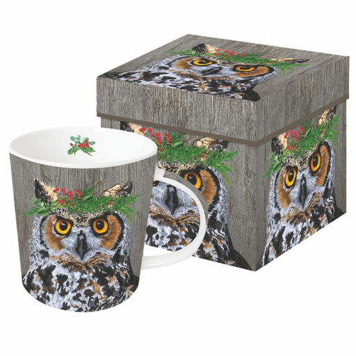 Mug with great horned owl wearing festive holiday evergreen crown. Big bright yellow eyes all on a on grey toned wood backround