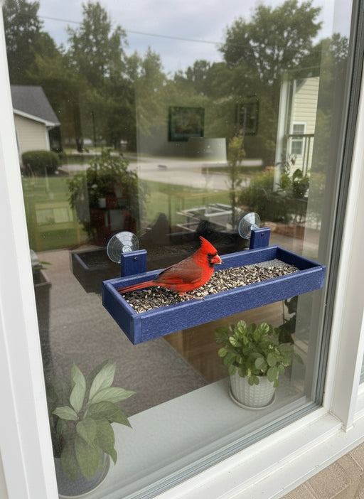 blue window mounted bird feeder with cardinal eating at the tray.
