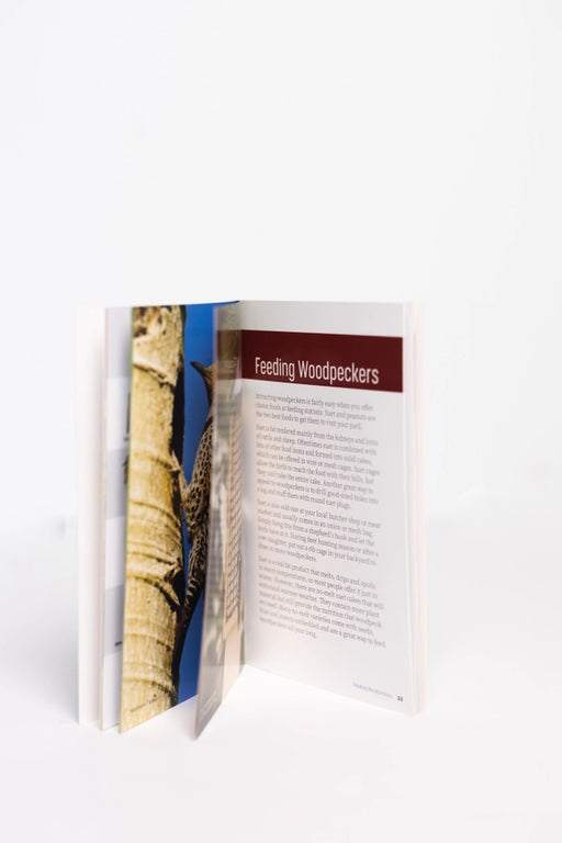 Open book showing a page with a picture of a tree and text on a white background