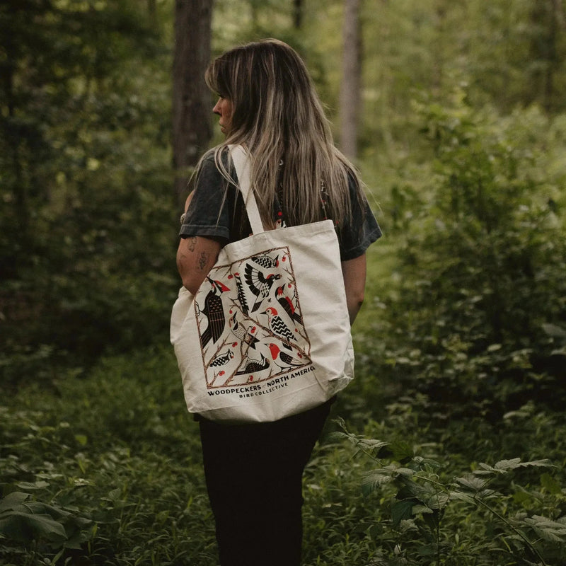 Woodpeckers of North America Tote Bag
Person walking in a forest with a tote bag featuring woodpecker illustrations.