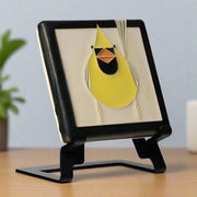 yellow cardinal tile on an easel against a white background. (easel not included)