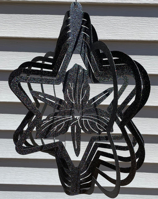 Trillium Wind Spinner in Rainbow Black with siding background
