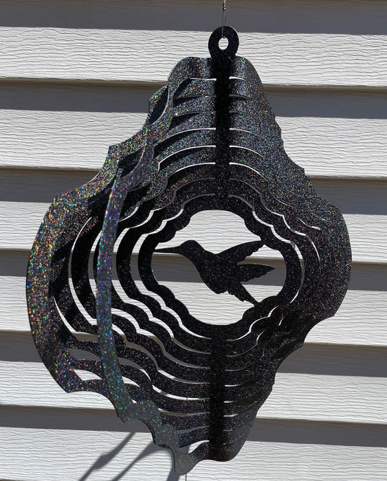 Hummingbird Wind Spinner in Rainbow Black with siding background
