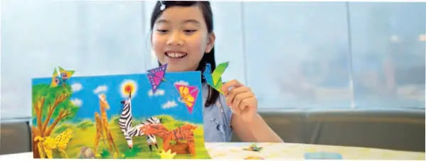 Girl playing with origami animals